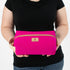 a woman holding a hot pink toiletry kit named after Kristen 
