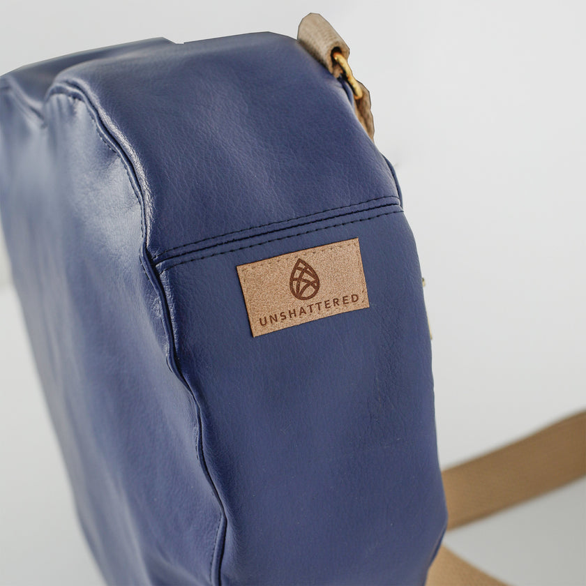 A close-up of the tan label on the heart bag upcycled from southwest airlines seat leather