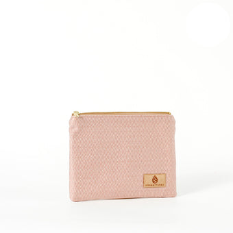 A soft pink chevron zippered pouch made from upcycled materials, with gold-tone hardware and a visible brand label named after Lakota