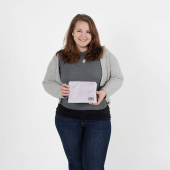 Woman holding a light purple zip pouch  against a white background named after Jaimilee