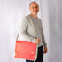 A man carrying the red formula e racing large messenger 