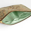 A mint green interior with a gold tone zipper on a tan floral large zip pouch on the exterior