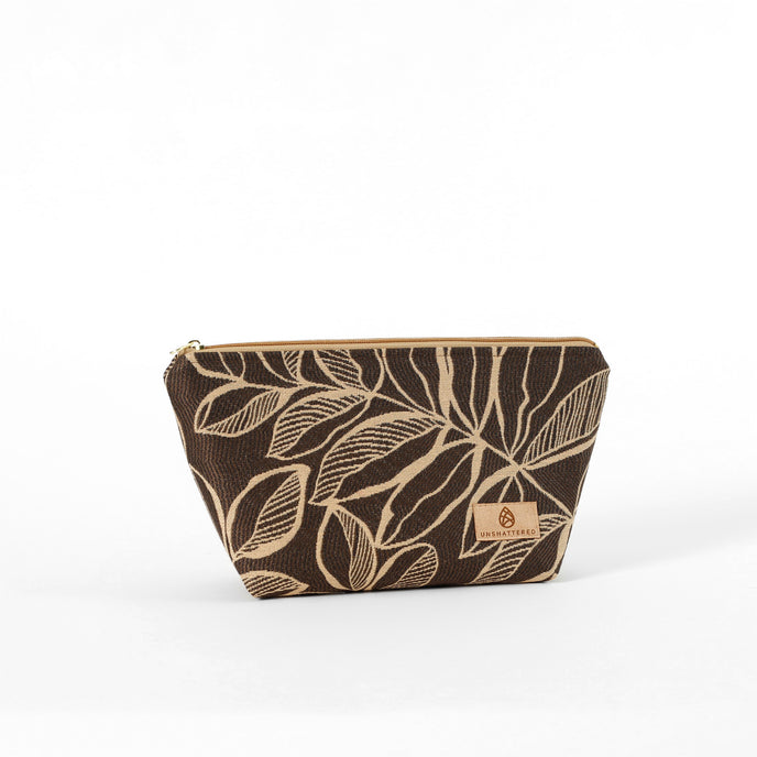 An eye-catching brown leaf patterned fabric makeup bag on a white background named after Lizzie