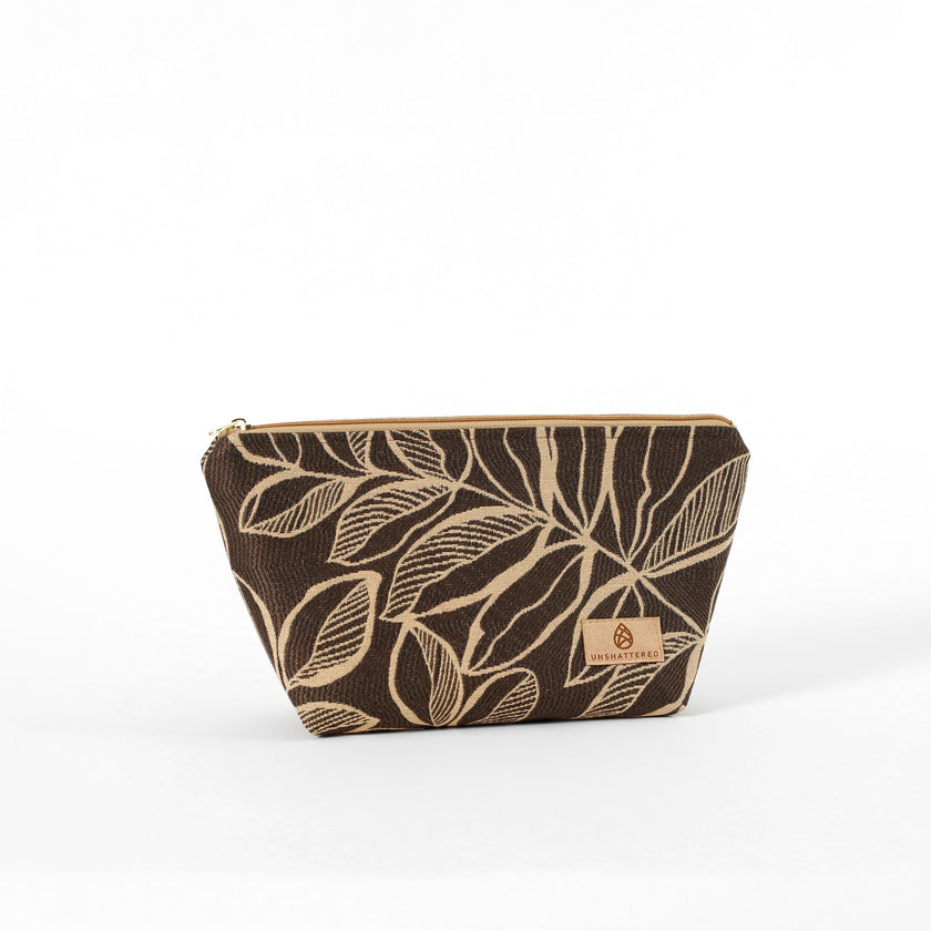 An eye-catching brown leaf patterned fabric makeup bag on a white background named after Lizzie