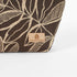 Tan suede Unshattered label on a brown leaf patterned fabric makeup bag named after Lizzie