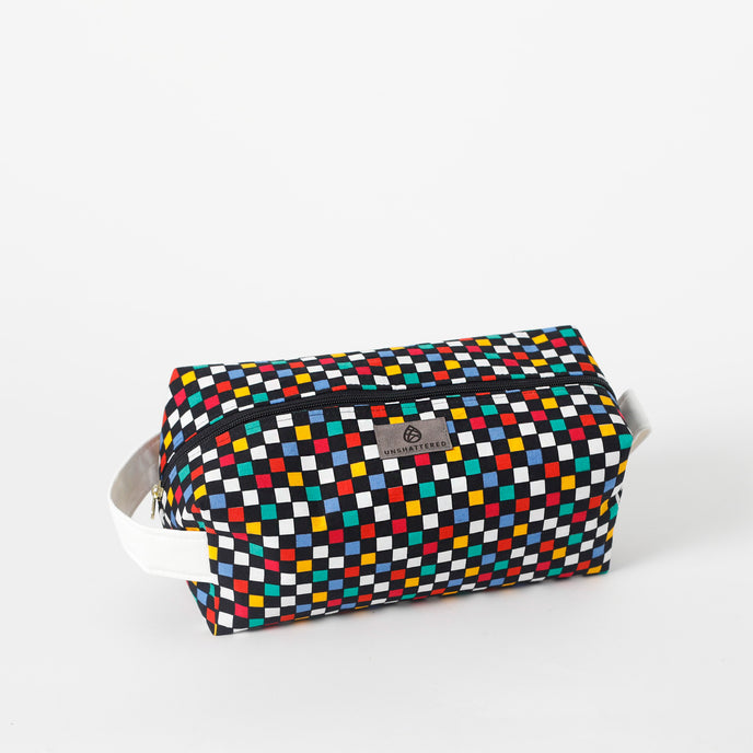 Multicolored checkered toiletry kit with a brand label on a white background named after Lyddin 