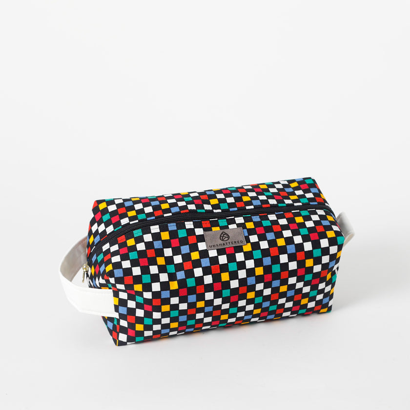 Multicolored checkered toiletry kit with a brand label on a white background named after Lyddin 