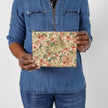 Hands holding a leaf design zip pouch wearing a jean shirt  named after Lynette