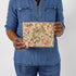 Hands holding a leaf design zip pouch wearing a jean shirt  named after Lynette