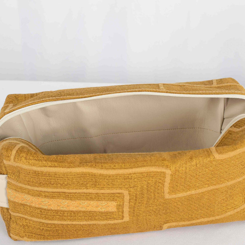 A cream luxury leather alternative material on a yellow line design toiletry kit 