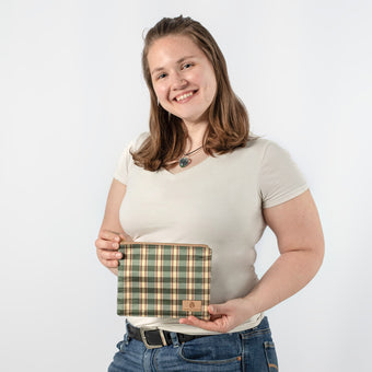 Person holding a plaid bag against a white background named after Molly