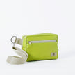 A vibrant lime green crossbody errand bag with zipper closure, an adjustable strap, and a silver-tone hardware, handcrafted from upcycled materials, bag named after Nadine.