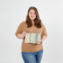 Woman holding a striped large zip pouch against a white background