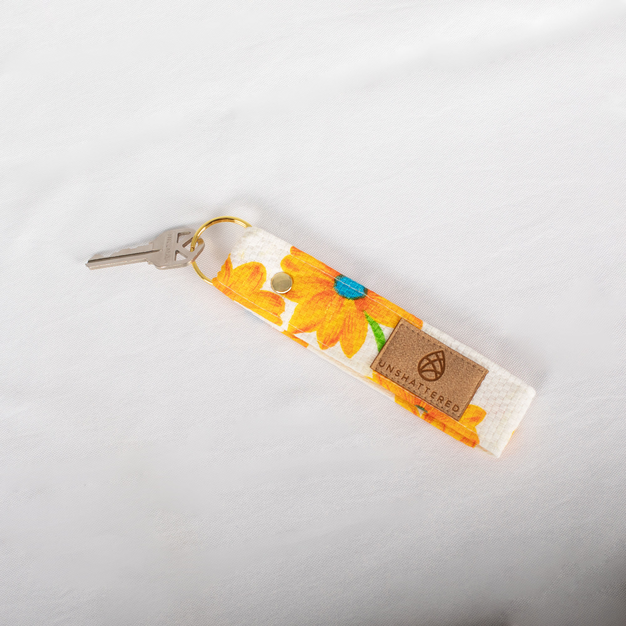 Loop Keychain made from upcycled floral fabric sits on a white cloth