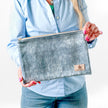 Person holding a large zip pouch handcrafted from upcycled blue velvet and named after Laura.