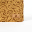 Patterned brown fabric with 'Unshattered' brand logo on a white background