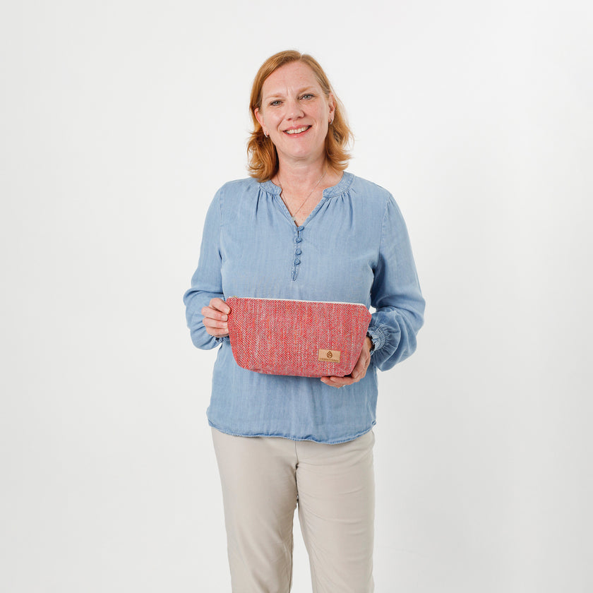 Lifestyle shot  person holding dee makeup bag