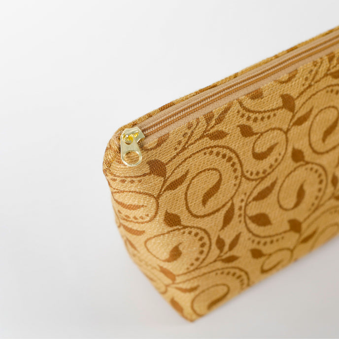 Brown ivy patterned fabric makeup kit with a zipper on a white background