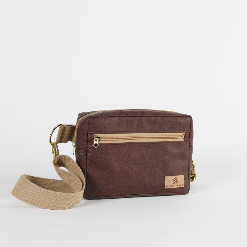 Brown vegan leather, errand bag with tan cotton strap on a white background named after Priscilla