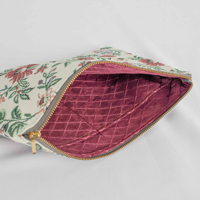 A burgundy x fabric interior on this white floral large zip pouch 
