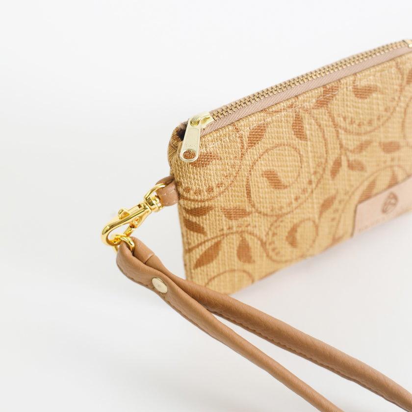Beige patterned clip pouch with gold zipper and tan strap on a white background