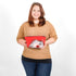 Person holding a red makeup bag named after Marie with a decorative design on a white background 