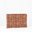 A large zip pouch with a red and beige diamond pattern and a visible brand logo on the lower right corner.