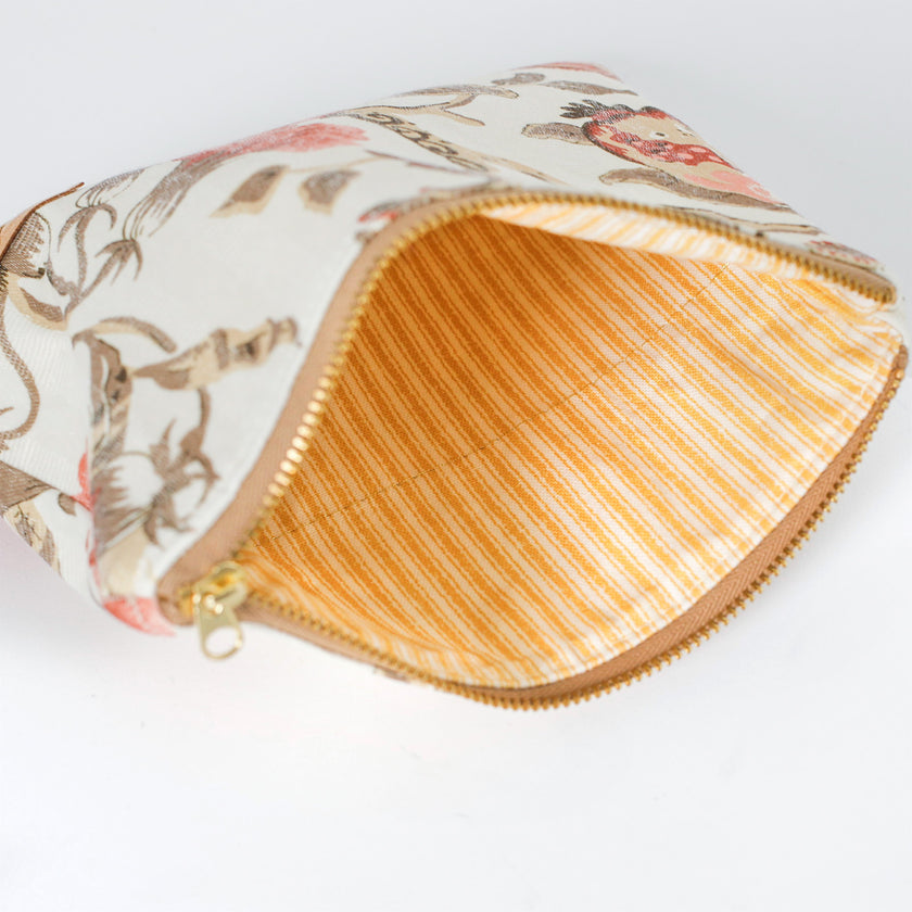 Floral-patterned pouch with a striped interior  on a white background named after Reisha 