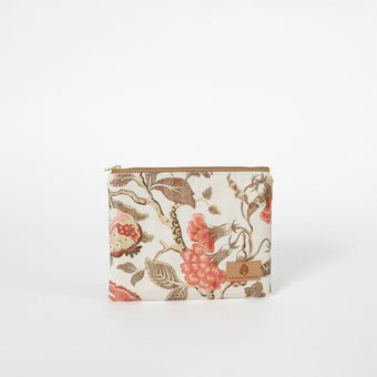 Floral patterned pouch with a brand logo on a white background named after Reisha