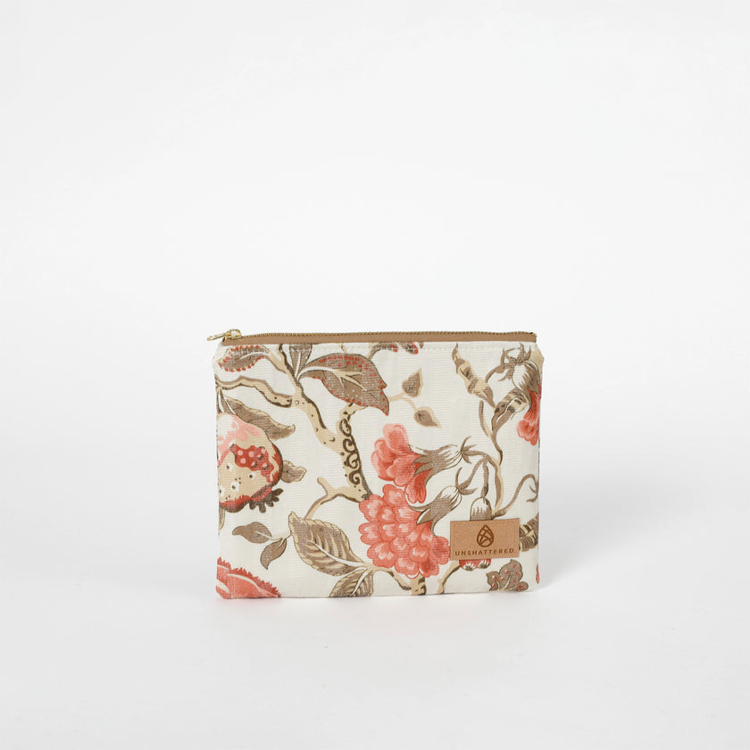 Floral patterned pouch with a brand logo on a white background named after Reisha
