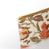 Floral-patterned pouch with a gold zipper on a white background named after Reisha