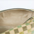 A close-up view of a cream-colored luxury leather alternative interior featuring elegant gold-toned stitching, showcased inside a checkered pattern upcycled toiletry bag.