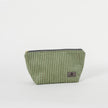 A green striped makeup kit with a zippered closure, made from upcycled materials.