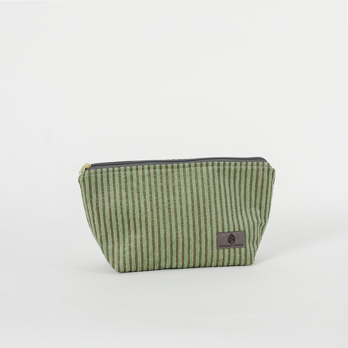 A green striped makeup kit with a zippered closure, made from upcycled materials.