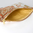 Decorative pouch with a patterned exterior and gold interior on a white background named after Sara