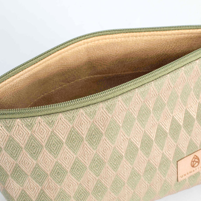 A tan luxury leather alternative interior on a beige and green diamond fabric on exterior makeup kit 