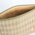 A tan luxury leather alternative interior on a beige and green diamond fabric on exterior makeup kit 