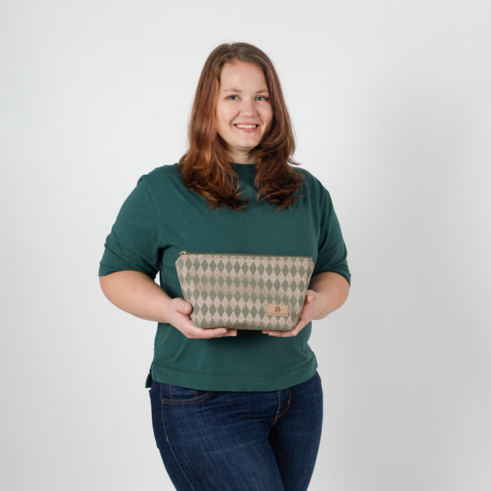 Woman holding a geometric  pouch against a plain background named after Sarah 