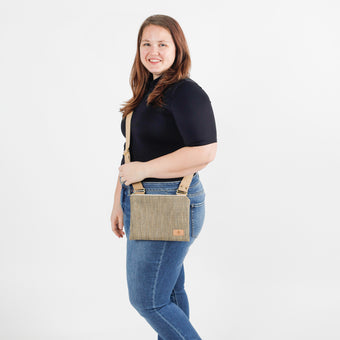 Woman wearing a crossbody bag on a white background