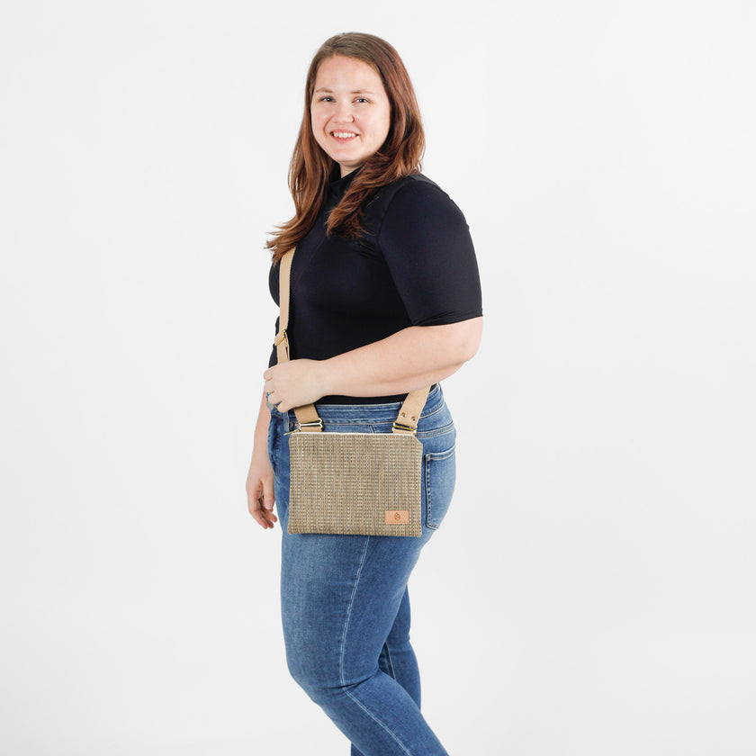 Woman wearing a crossbody bag on a white background
