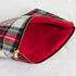A red interior fabric and gold tone zipper on a red plaid large zip pouch 