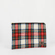 A large zip pouch with a red, green, and white plaid pattern and a small brand tag on the bottom right.