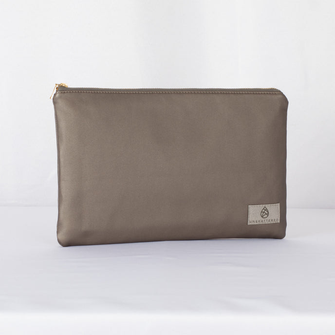 A large zip pouch in dark gray premium luxury leather alternative with a gold-tone hardware zipper, displayed against a white background.
