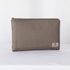 A large zip pouch in dark gray premium luxury leather alternative with a gold-tone hardware zipper, displayed against a white background.