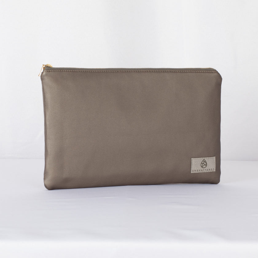 A large zip pouch in dark gray premium luxury leather alternative with a gold-tone hardware zipper, displayed against a white background.