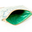 A bright shiny green interior on a floral design zip pouch bag named after Shelby 