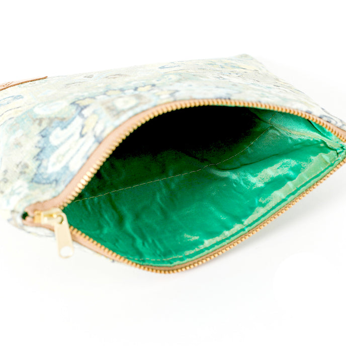 A bright shiny green interior on a floral design zip pouch bag named after Shelby 