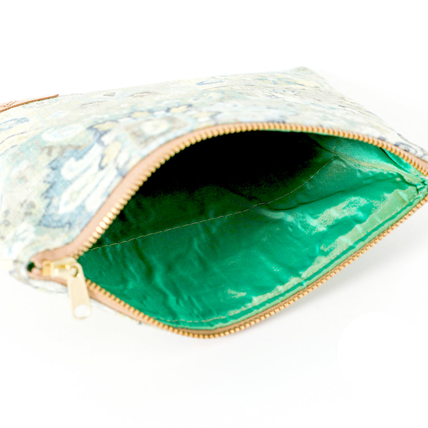 A bright shiny green interior on a floral design zip pouch bag named after Shelby 