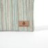Striped fabric with a 'Unshattered' brand label on a white background named after Sherry