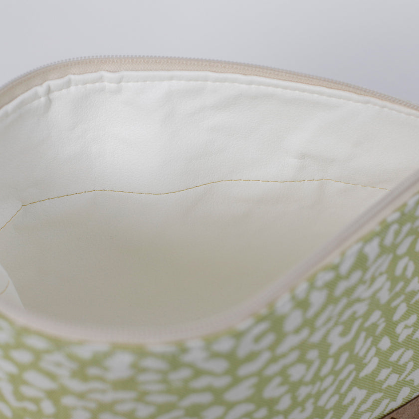 Close-up of a  white luxury leather alternative interior with green and white on the exterior named after Sky 
